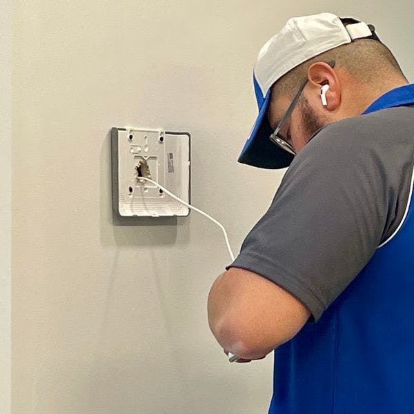 ADT technician installing control panel